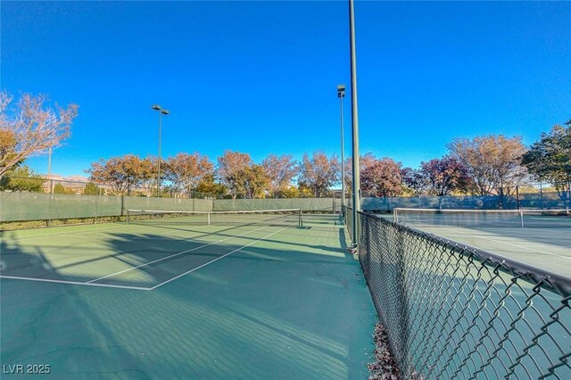 view of sport court featuring fence