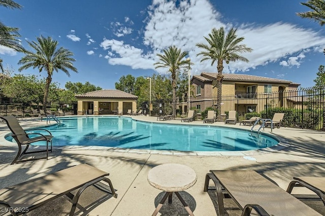 pool with fence and a patio