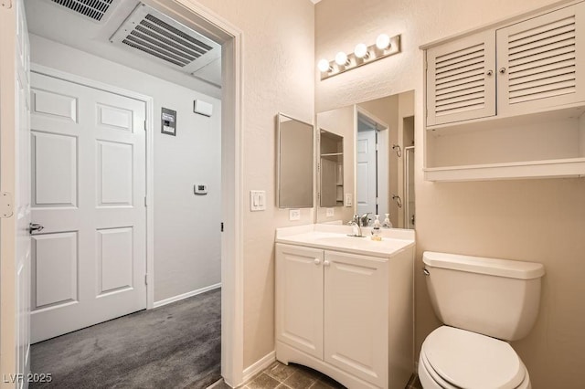 bathroom with visible vents, vanity, toilet, and baseboards