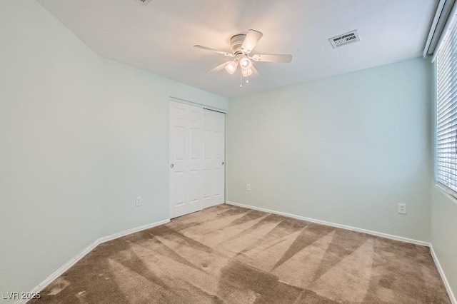 interior space featuring baseboards, visible vents, and ceiling fan