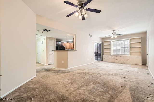 unfurnished living room with light carpet, baseboards, and visible vents