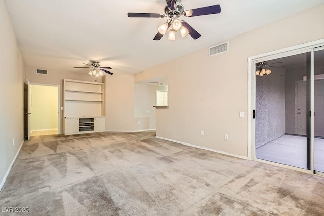 unfurnished living room featuring ceiling fan, carpet flooring, visible vents, and baseboards