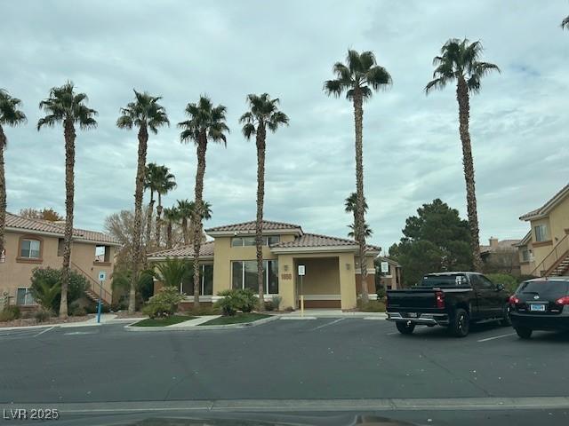 view of building exterior with uncovered parking