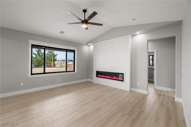 unfurnished living room with visible vents, baseboards, light wood-type flooring, vaulted ceiling, and a fireplace