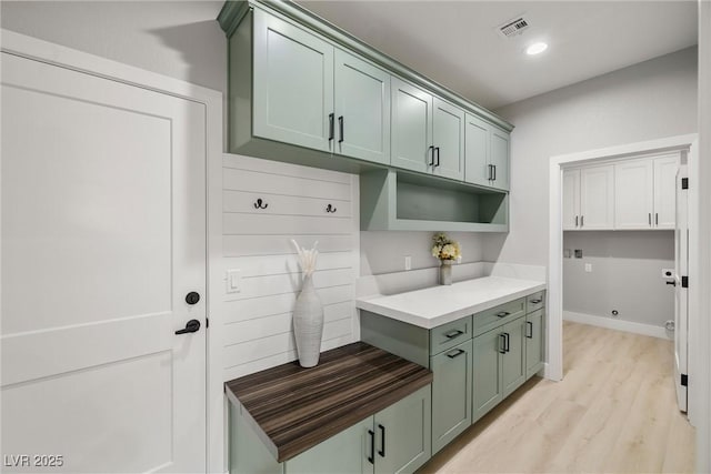 mudroom with recessed lighting, visible vents, baseboards, and light wood finished floors