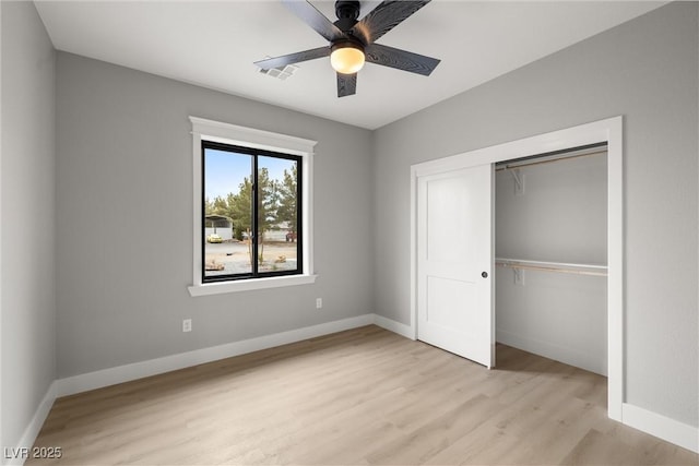 unfurnished bedroom featuring a closet, baseboards, and light wood finished floors