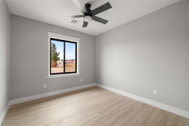 unfurnished room with visible vents, baseboards, light wood-style flooring, and a ceiling fan