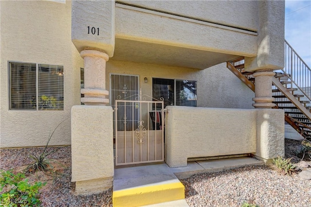 entrance to property featuring stucco siding