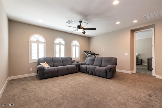 living room featuring recessed lighting, visible vents, and light colored carpet