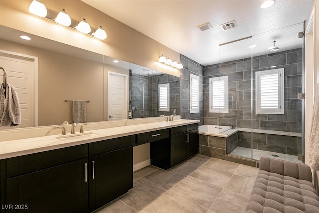 full bathroom featuring a bath, a stall shower, a sink, and visible vents