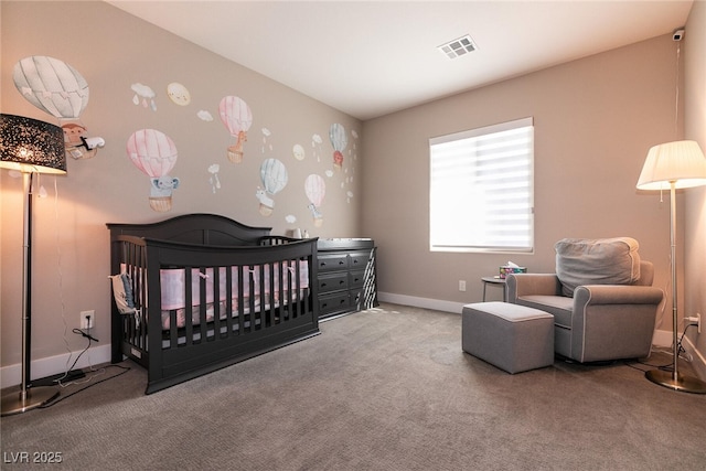 bedroom with baseboards, a crib, visible vents, and light colored carpet