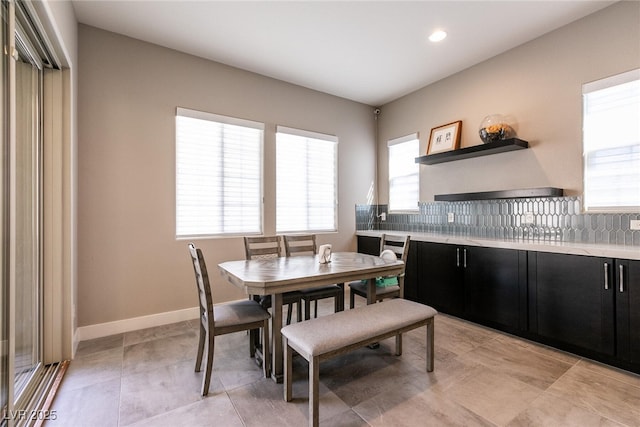 dining space featuring light tile patterned floors, baseboards, and recessed lighting