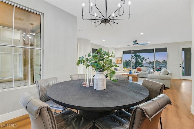 dining room featuring light wood-style floors, recessed lighting, baseboards, and ceiling fan with notable chandelier