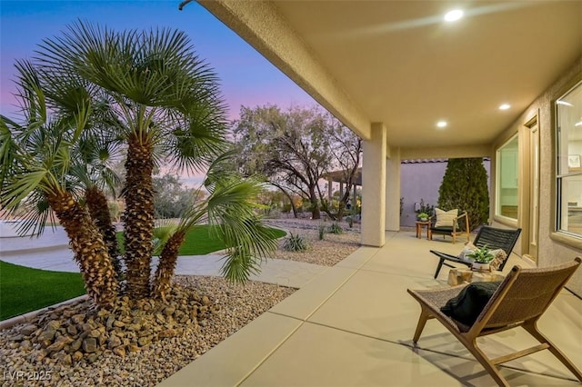 view of patio terrace at dusk