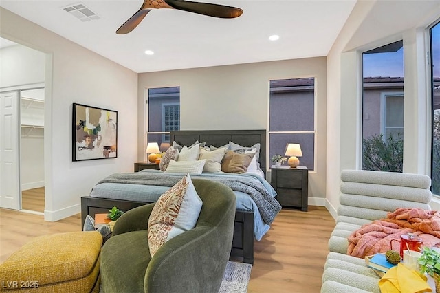 bedroom with recessed lighting, light wood-type flooring, visible vents, and baseboards