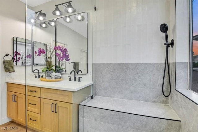 bathroom featuring wood finished floors, a sink, and double vanity