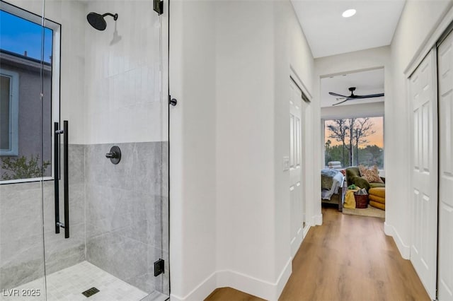 hallway with wood finished floors and baseboards