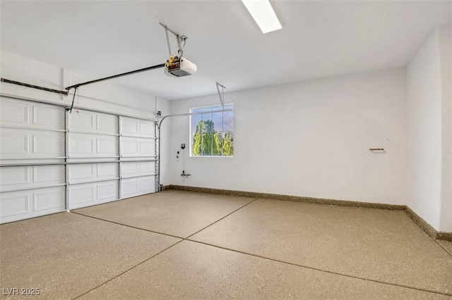 garage with a garage door opener and baseboards