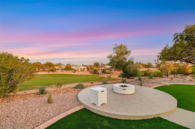 exterior space with an outdoor fire pit and a lawn