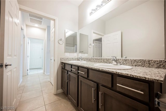 full bath with double vanity, tile patterned flooring, visible vents, and a sink