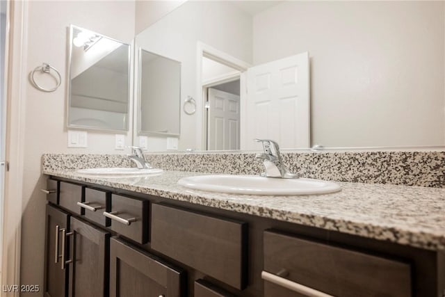 full bath with a sink and double vanity