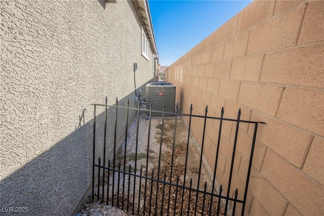 exterior space featuring fence and central AC unit