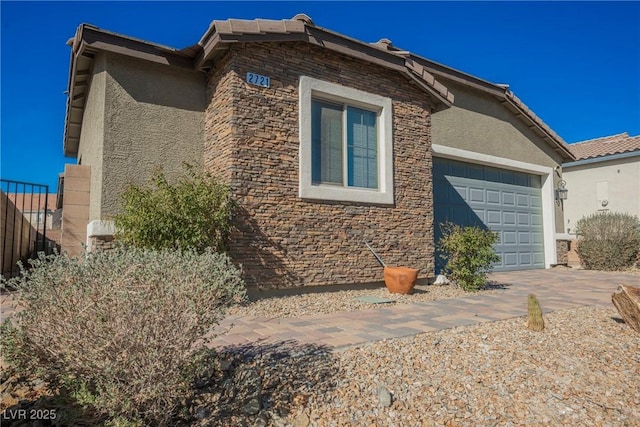 view of home's exterior with an attached garage and stucco siding