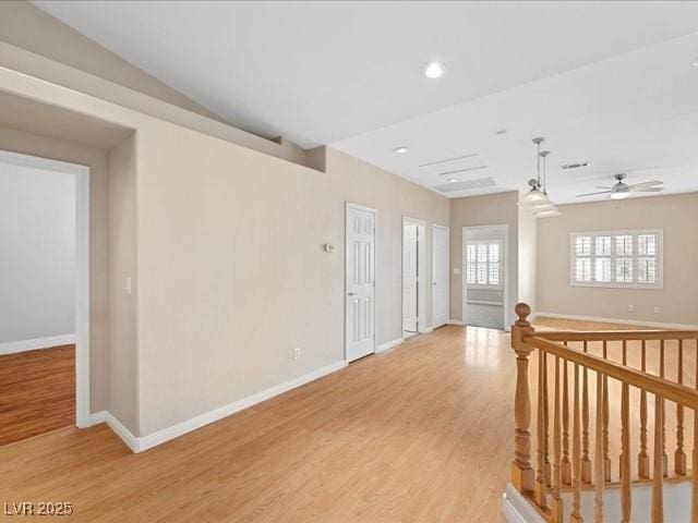 corridor featuring an upstairs landing, light wood-type flooring, baseboards, and recessed lighting