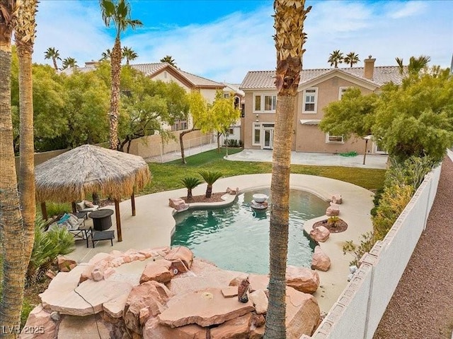 outdoor pool featuring a lawn, a patio, a fenced backyard, a gazebo, and french doors