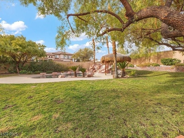 view of yard featuring fence and a patio