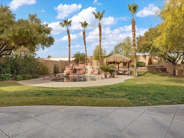 exterior space with a yard, fence, and a gazebo