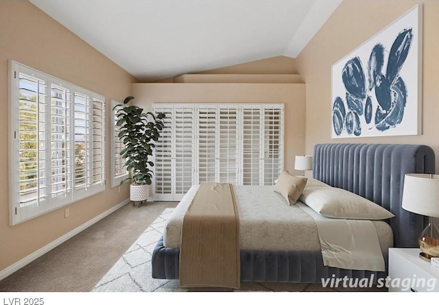 bedroom featuring light carpet, vaulted ceiling, and baseboards