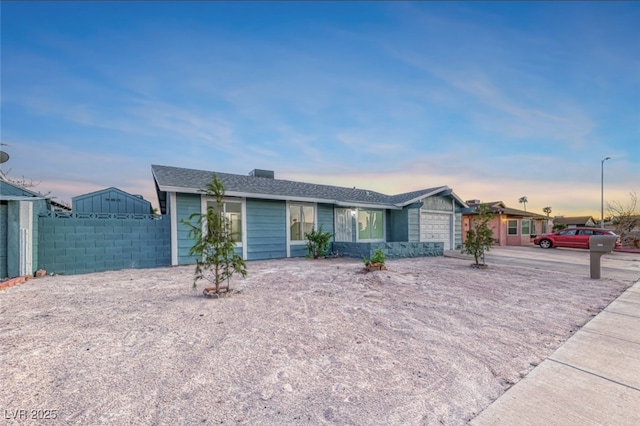 ranch-style house featuring fence