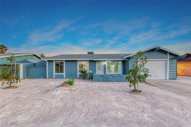 single story home featuring a garage and concrete driveway