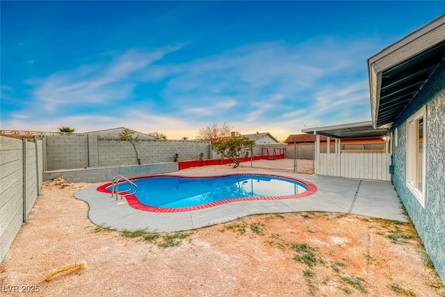 view of pool with a fenced in pool, a fenced backyard, and a patio