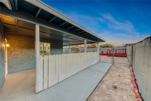 patio terrace at dusk with a gate and fence