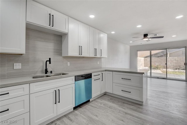 kitchen featuring white cabinetry, dishwasher, and a sink