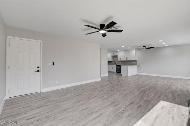 unfurnished living room with light wood finished floors, baseboards, a ceiling fan, and recessed lighting