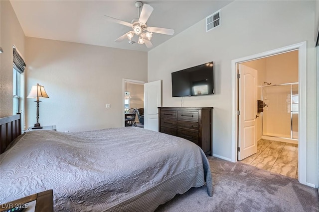 bedroom with light colored carpet, visible vents, ensuite bathroom, a ceiling fan, and vaulted ceiling