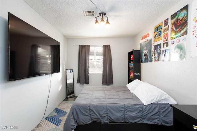 bedroom featuring visible vents and a textured ceiling