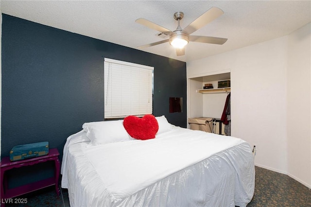 bedroom with baseboards, visible vents, ceiling fan, dark colored carpet, and a textured ceiling