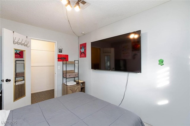 bedroom featuring a textured ceiling and visible vents