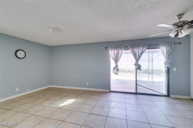 unfurnished room featuring light tile patterned floors, ceiling fan, and baseboards