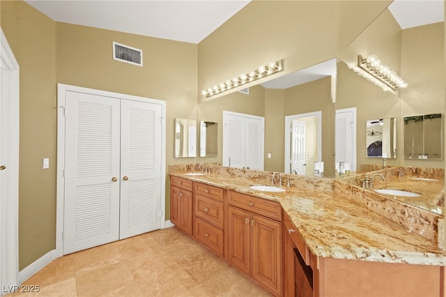 full bathroom with a closet, visible vents, and a sink