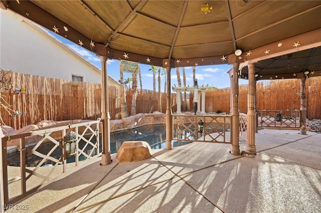 view of patio featuring a fenced backyard and a gazebo