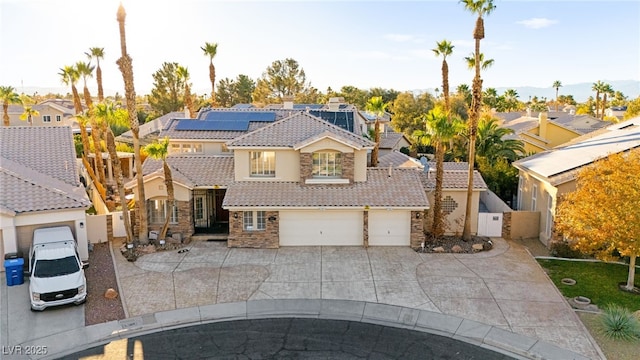 view of front of home featuring a residential view, stone siding, a tile roof, and solar panels