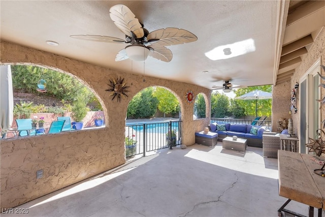 view of patio / terrace with a ceiling fan, an outdoor living space, and a fenced in pool