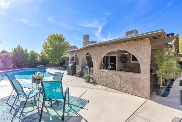 view of patio / terrace featuring an outdoor pool and central AC