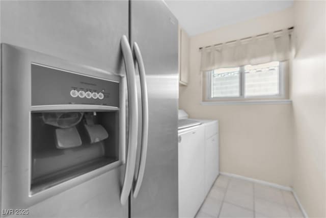 laundry room featuring laundry area, light tile patterned flooring, baseboards, and independent washer and dryer