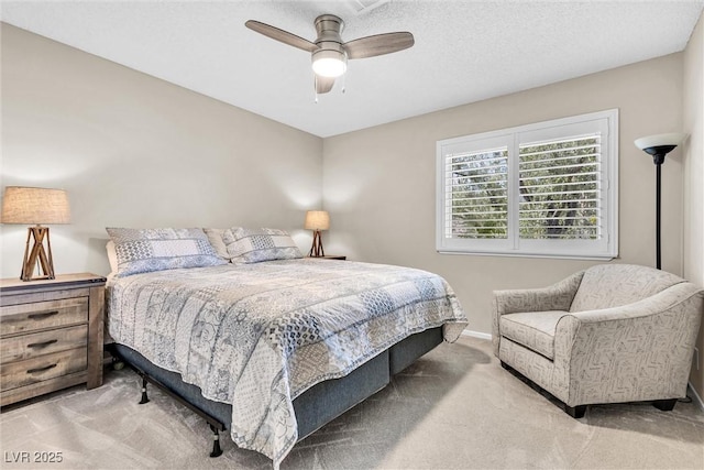 carpeted bedroom featuring a textured ceiling, baseboards, and a ceiling fan